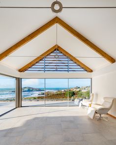 an open room with large windows overlooking the ocean