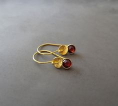 "These beautiful 24k gold vermeil earrings feature a genuine faceted garnet and twisted textured bead. Vermeil is a thick coat of 24 karat gold on solid sterling silver. Garnet is the birthstone for January. These earrings would make a perfect gift for any occasion. Total length: 2.3 cm (0.9\") Width: 6mm The earrings will come in a beautiful gift box. * CHECK OUT MORE JEWELLERY * www.etsy.com/shop/kailajewellery" Gold Garnet Earrings As Gift, Thick Coat, Birthstone Earrings, Ruby Necklace, January Birthstone, Garnet Earrings, Ruby Earrings, Birthstone Earring, Beautiful Gift Boxes