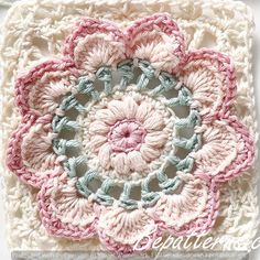 a crocheted square with a flower on it