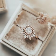 an engagement ring sitting on top of a box