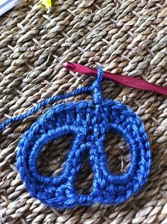 a crochet peace sign is on the table next to scissors