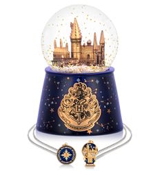 a snow globe with hogwart's castle in it and two pendants attached