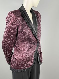 JEAN LOUIS SCHERRER - Evening jacket The model is cut from viscose with a pleated effect, brown in color tending towards plum. It has long, shouldered sleeves with a slit cuff and is lined with black pleated satin trimmed with velvet. The shawl collar is worked identically to the sleeves and the jacket closes on the front with a single button. Two pockets. The interior is lined with black viscose The label is sewn on the back: Jean louis Scherrer Boutique Paris Made in France Approximately size Tuxedo Collar, Jean Louis Scherrer, Evening Jacket, Evening Jackets, Shawl Collar, Shoulder Sleeve, Made In France, Plum, Shawl