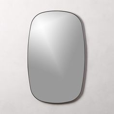 an oval mirror hanging on the wall