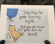 a winnie the pooh birthday card with a balloon floating from it's back