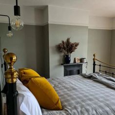 a large bed with yellow pillows in a bedroom