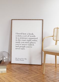 there is a framed quote on the wall next to a chair and lamp in this room