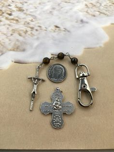 This mens rosary keychain is very unique as it has brown tigers eye beads - Giving it a very manly look. This keychain features three beads. You can choose what prayers you would like to say but our Father, Hail Mary and Glory Be would be appropriate as you head off to drive for safe travel. My keychains are carefully made by me and will not come apart with daily use. Each eye piece is wrapped so they can not come apart. Materials used: ~6mm tigers eye beads ~20 gauge Stainless Steel Wire ~JohnP Rosary Keychain, Mens Keychain, Mens Rosary, Glory Be, Catholic Cross, Brown Tiger Eye, Safe Travels, Hail Mary, Tiger Eye Beads