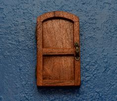 a wooden door on the side of a blue wall