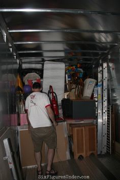 a man standing in the back of a moving truck