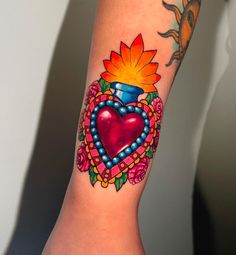 a woman's arm with a tattoo on it and a heart in the center