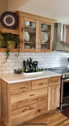 a kitchen with wooden cabinets and white tile backsplash