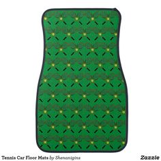 a green floor mat with tennis rackets and balls all over the pattern on it