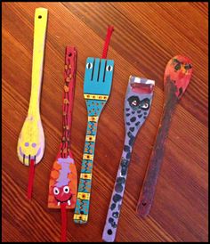 five different types of toothbrushes on a wooden table with one painted like an animal