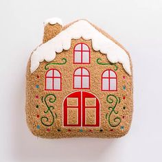 a gingerbread house is decorated with icing