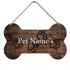 a wooden sign that says pet names with two dogs paw prints on the front and back