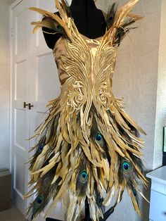 a dress made out of feathers on a mannequin