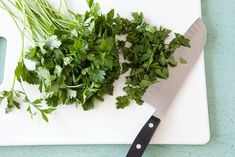 chopped parsley on cutting board next to knife