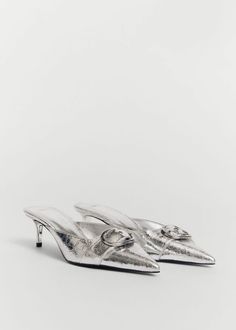 two silver shoes on top of each other