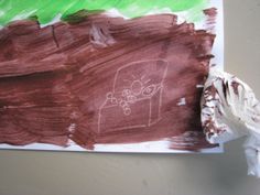 a child's drawing on a piece of paper that is taped to the wall