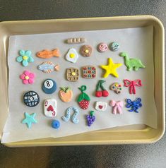 a tray filled with lots of different types of magnets on top of paper towel