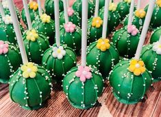 there are many green cake pops with flowers on them