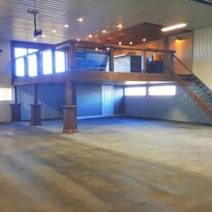 an empty garage with stairs leading up to the second floor