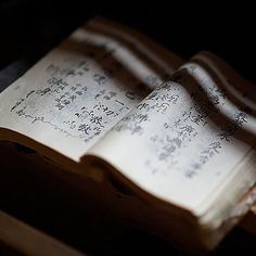 an open book sitting on top of a wooden box