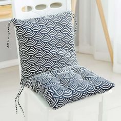 a white chair with a black and white pattern on it