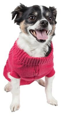 a small dog wearing a pink sweater with its tongue out and it's mouth open