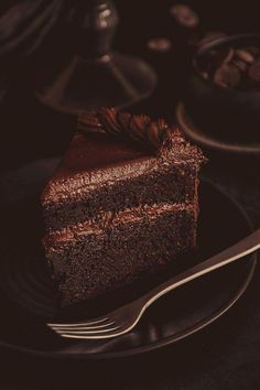 a piece of chocolate cake on a plate with a fork