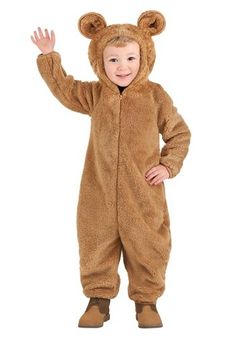 a little boy in a bear costume standing on one leg with his hand up to the side