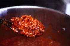 a spoon full of chili sauce in a pot