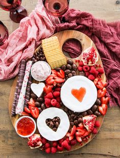 a platter with chocolate, strawberries, crackers and heart shaped marshmallows