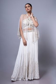 White padded blouse featuring floral hand embroidery all over. Paired with an embroidered palazzo and a sheer cape. - Aza Fashions Wedding Top With Intricate Embroidery On Georgette, White Resham Embroidery Top For Wedding, Sleeveless Resham Embroidered Fabric For Wedding, Wedding Tops With Floral Embroidery In Georgette, Sleeveless Embroidered Fabric For Wedding, Sleeveless Wedding Fabric With Resham Embroidery, Elegant Sleeveless Embroidered Top For Weddings, Sleeveless Georgette Blouse With Intricate Embroidery, Sleeveless Blouse With Dupatta For Wedding