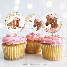 three cupcakes with pink frosting and horse decorations on top, sitting next to each other