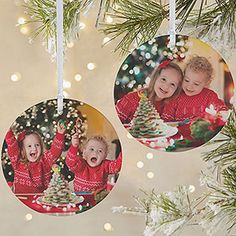 two christmas ornaments hanging from a tree