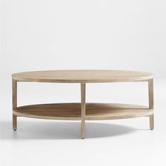 a round wooden table with two shelves on each side and one shelf below the coffee table