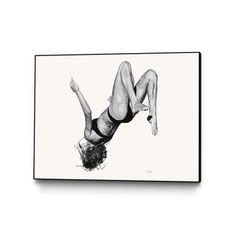 a black and white photo of a woman doing a handstand on her stomach