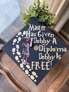 a decorated graduation cap with the words master has given a dobby diploma, dobby is free