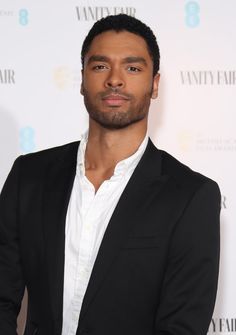 a man in a black suit and white shirt