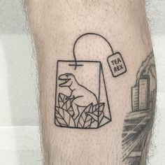 a man's leg with a black and white tattoo on it that says tea fix