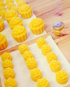 some yellow cupcakes sitting on top of paper next to a can of butter