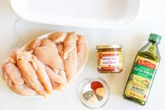 the ingredients to make this dish include chicken, seasoning, and spices on a white counter top