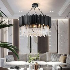 a living room with couches and a chandelier