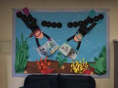 a bulletin board with two monkeys hanging from it's sides and under the words dive into reading