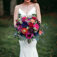 a woman holding a bouquet of flowers in her hands