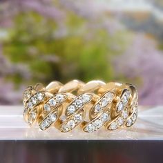 an image of a gold ring with diamonds