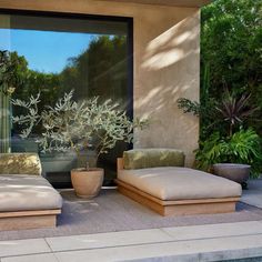 two lounge chairs sitting next to each other near a pool