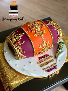 a birthday cake decorated with an orange and pink crown on top of a white plate